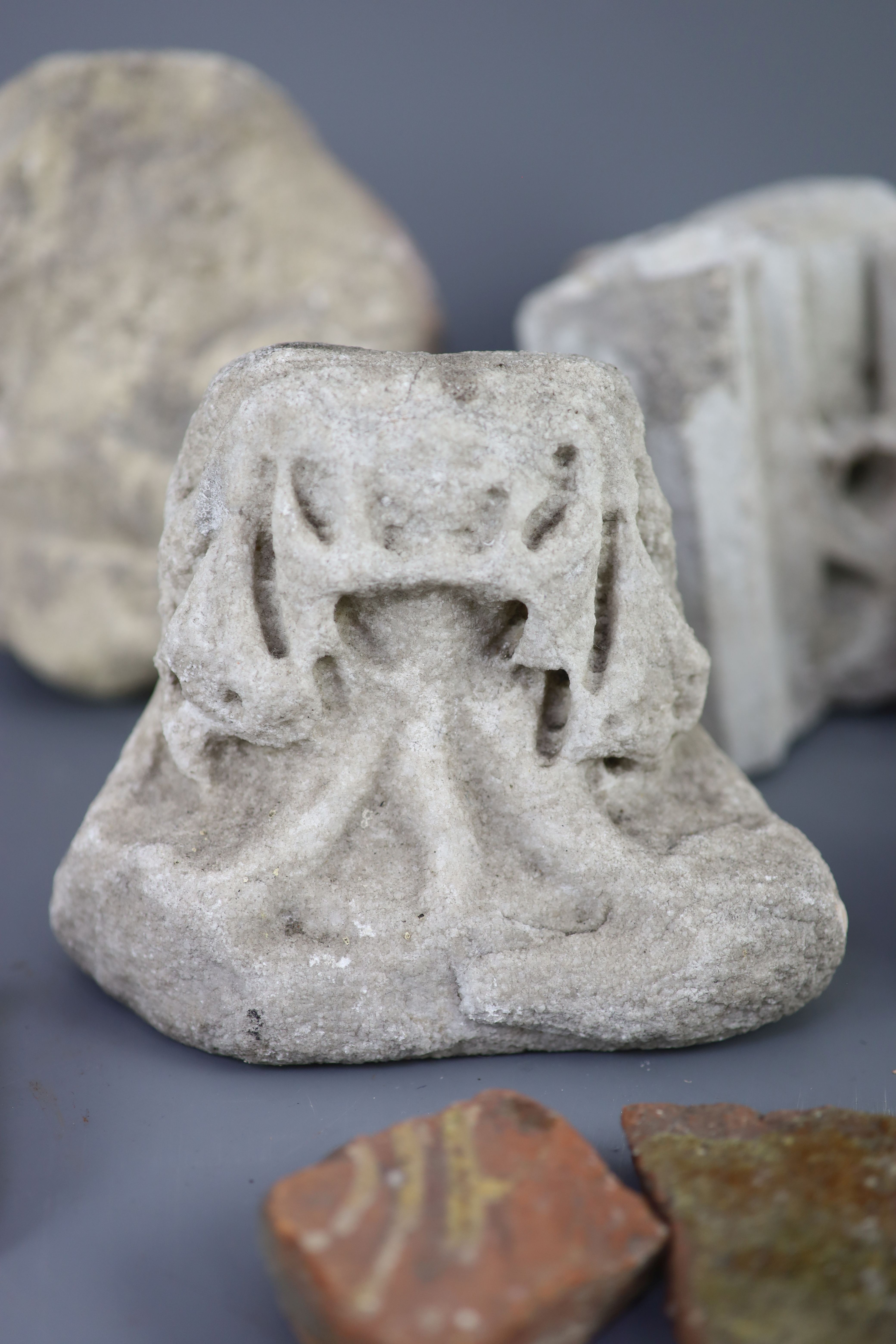 A group of English medieval church/priory architectural stonework and tile fragments, some pieces with inscribed labels of provenance,